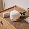 NEOM Pod Luxe with essential oils on a chest of drawers