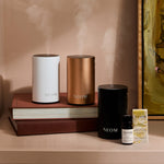 NEOM pod mini+ in black, white and rose gold with a focus the mind essential oil blend