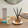 NEOM real luxury reed diffuser and box on a weaved table