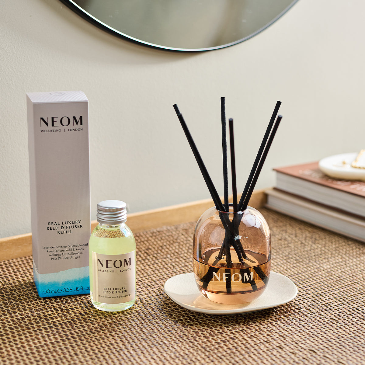 NEOM real luxury reed diffuser and box on a weaved table