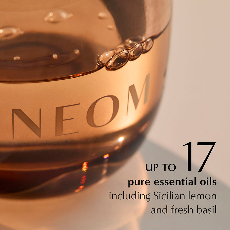 Close-up of NEOM diffuser oil showing up to 17 essential oils including Sicilian lemon and fresh basil