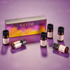 NEOM essential oil blend set on a purple background