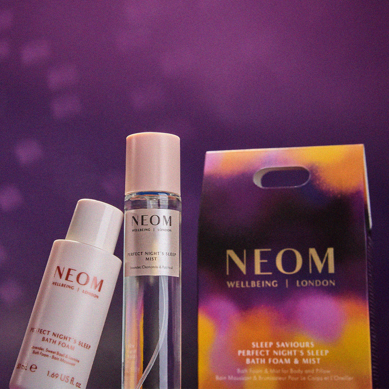 NEOM skincare products with packaging on a purple background