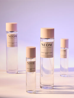 NEOM Perfect Night’s Sleep mist bottles with lavender, chamomile and patchouli on soft gradient background.