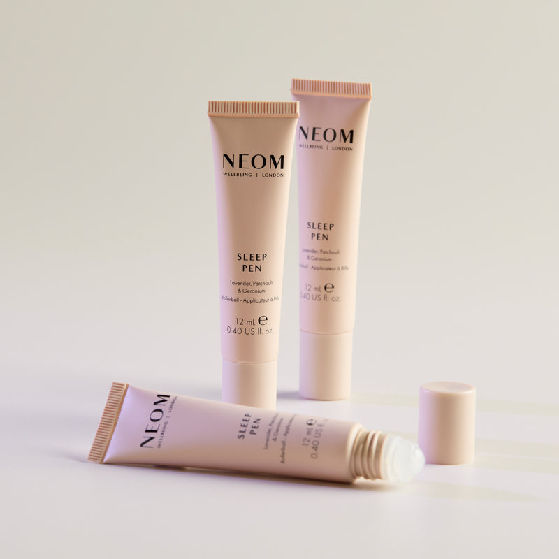 Three NEOM Sleep Pens on a light background