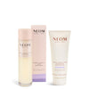 NEOM skincare products including bath foam and body butter on a white background