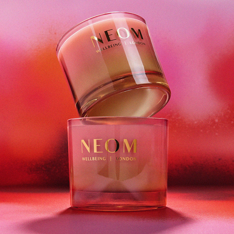 Two NEOM skincare products on a pink background