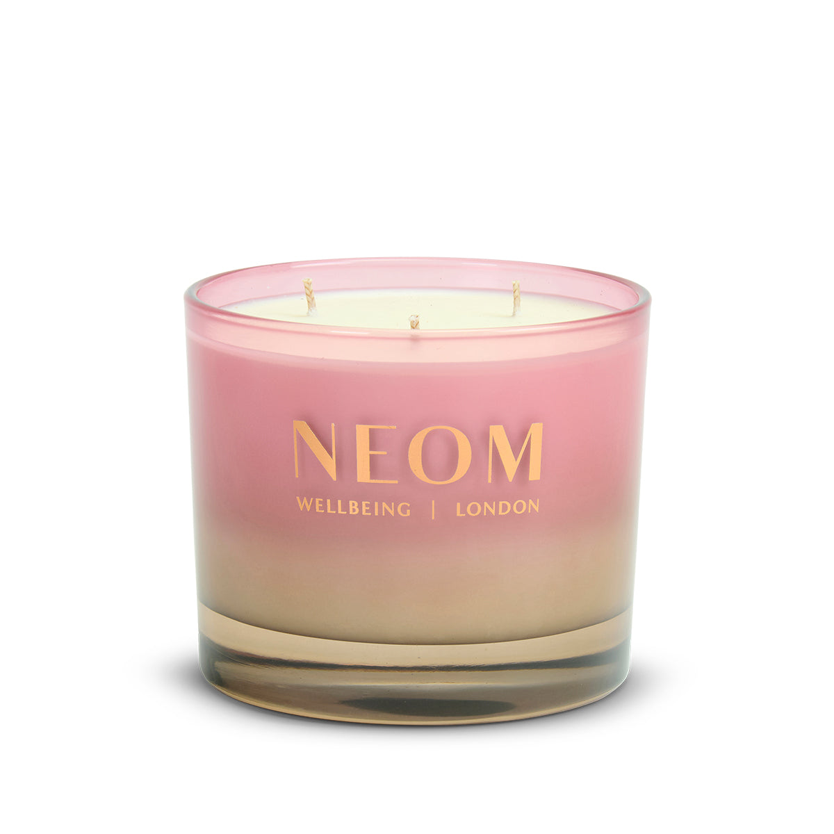 NEOM Sparkling Joy 3 Wick Scented Candle with pink and beige gradient on a white background