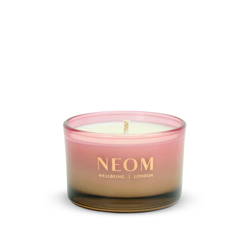NEOM Sparkling Joy Travel Scented Candle with a gradient design on a white background