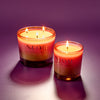 Two NEOM candles on a purple background