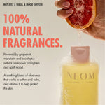 “NEOM Squeeze the Day Body Wash with foam, while a hand squeezes a grapefruit above it. Text reads: ‘Not just a wash, a mood switch! 100% natural fragrances.’ Additional text: ‘Powered by grapefruit, mandarin and eucalyptus – natural oils known to brighten and uplift mood. A soothing blend of aloe vera that works to soften and calm, and vitamin E to help protect the skin.’”