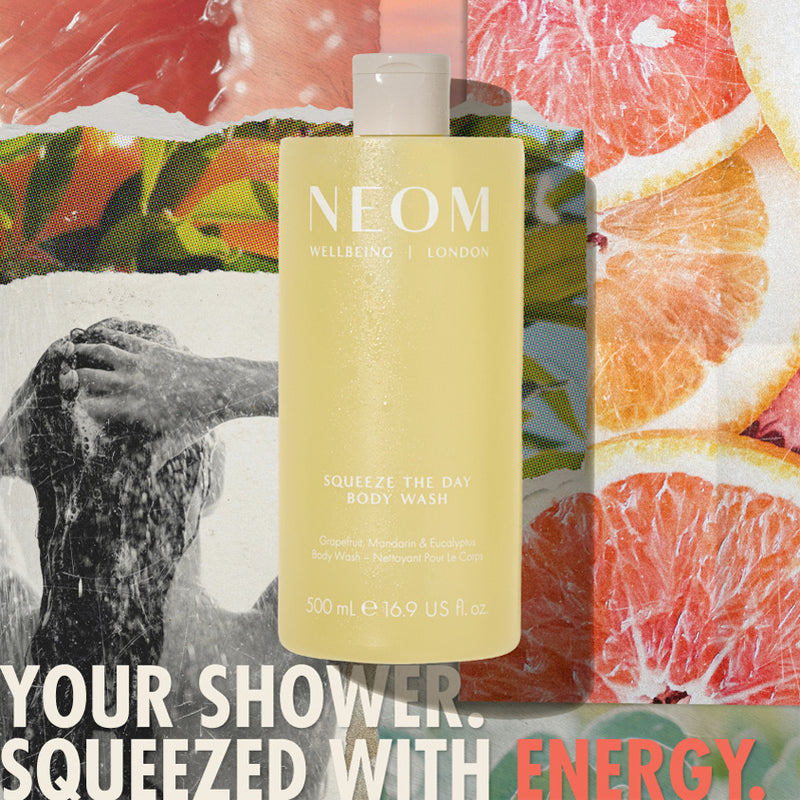 “NEOM Squeeze the Day Body Wash (500 ml) centered over a collage of grapefruit slices and a person showering. Text reads: ‘Your shower. Squeezed with energy.’”