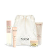 NEOM Sweet Dreams Travel Kit  including a pillow mist, sleep pen, wonder balm and body butter with a white drawstring bag on a white background.