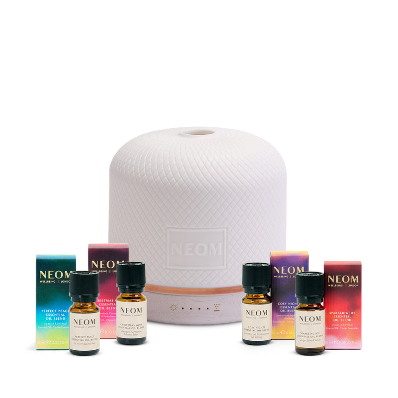 NEOM diffuser and essential oils on a white background