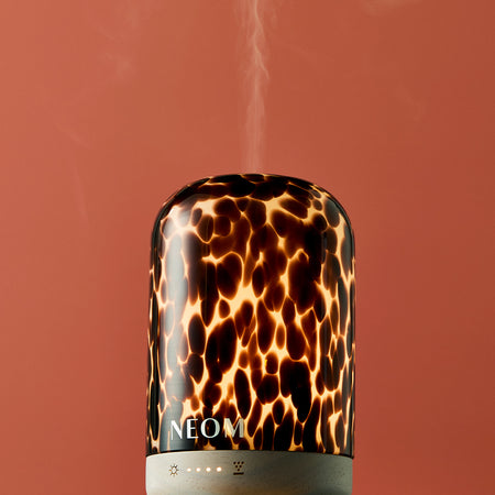 Leopard print NEOM limited edition electric pod diffuser on a red background