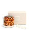 NEOM diffuser with tortoiseshell pattern and matching packaging on a white background
