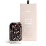 NEOM diffuser with tortoiseshell glass cover and packaging on a white background