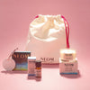 NEOM products and a drawstring bag on a pink background