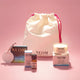 NEOM products and a drawstring bag on a pink background