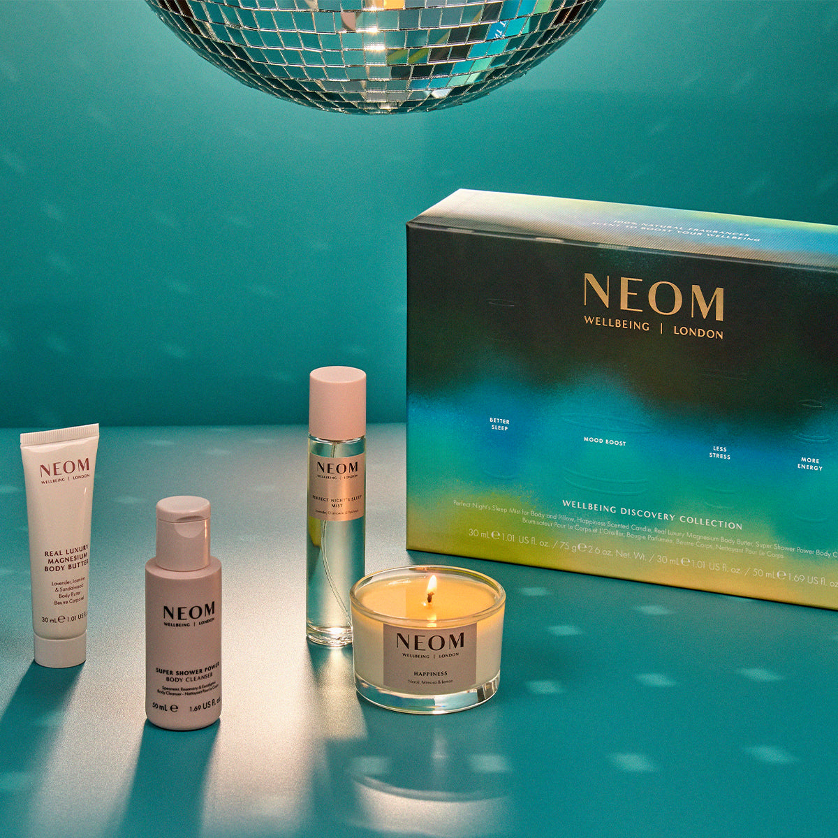NEOM wellness products including candles on a teal background with disco ball