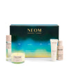 NEOM Wellbeing skincare and candle set on a white background