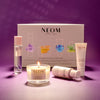 NEOM wellness collection with products on a purple background