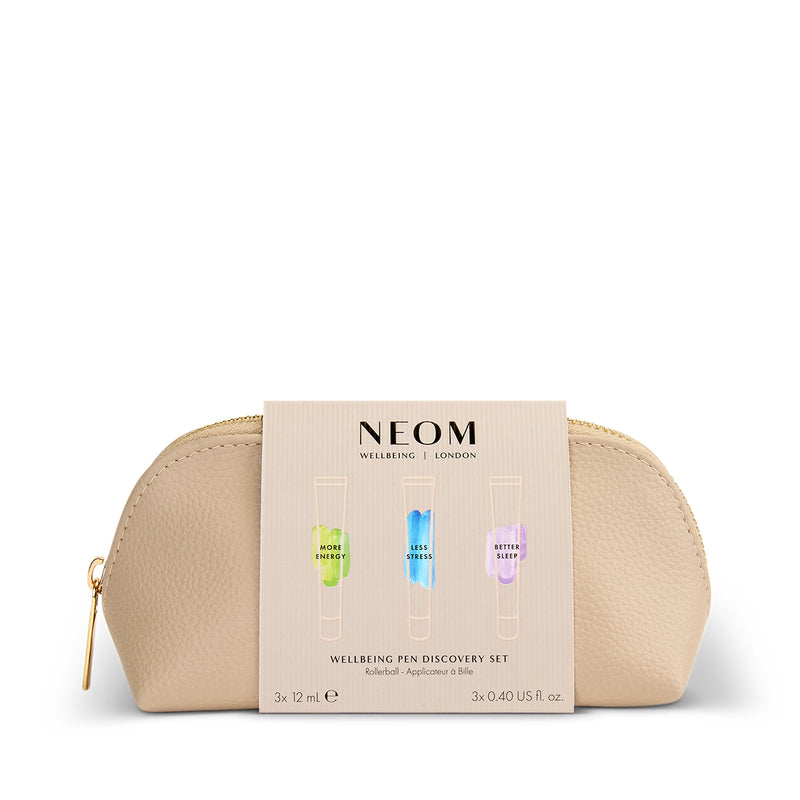 NEOM wellbeing pen discovery set in a gold pouch on a white background