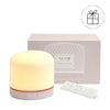 NEOM Pod essential oil Pod Luxe diffuser with packaging on a white background with a Perfect Gift roundel with a present
