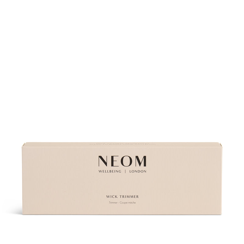 NEOM wick trimmer box with 'Wellbeing London' text on a white background