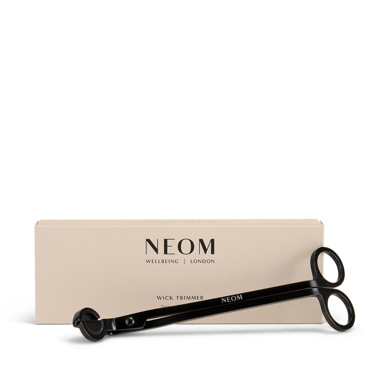 NEOM black wick trimmer with packaging on a white background
