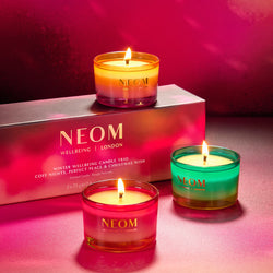 NEOM candles with a pink box in the background