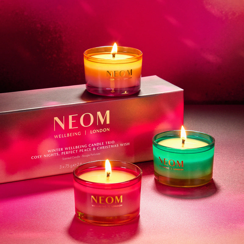 NEOM candles with a pink box in the background