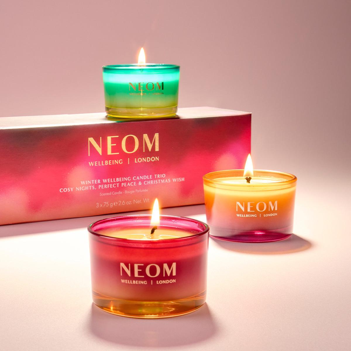 NEOM travel candles with a pink box in the background