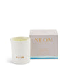 NEOM candle and packaging on a white background